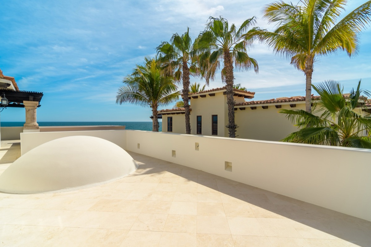 Oceanfront villa terrace with palms in Los Cabos